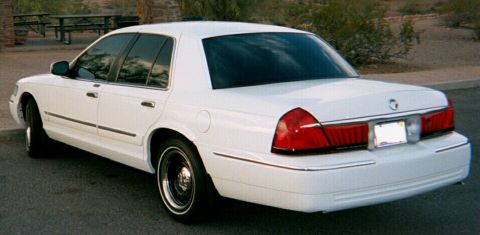 2001 Mercury Grand Marquis - Rear view of a white 2001 Mercury Grand Marquis sedan parked outdoors.