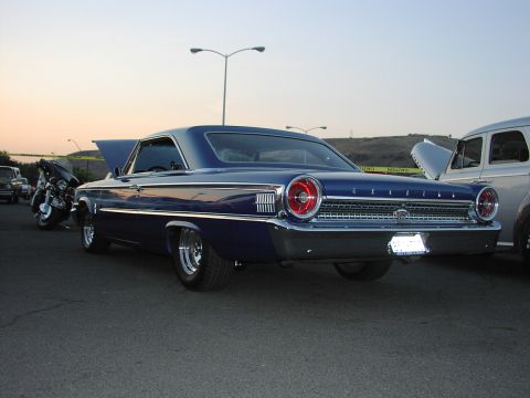1979 Ford Bronco - Rear view of a blue 1963 Ford Galaxie 500 coupe with chrome wheels.