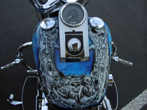 1979 Ford Bronco - The custom airbrushing on this motorcycle's gas tank features a macabre theme with skulls and grimacing faces.