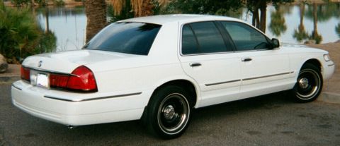 2001 Mercury Grand Marquis - This 2001 Mercury Grand Marquis is parked outdoors near a body of water.