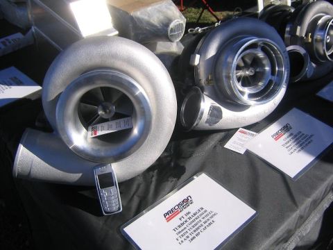 1969 Ford Mustang - Two Precision turbochargers are displayed with product information sheets and a cell phone.