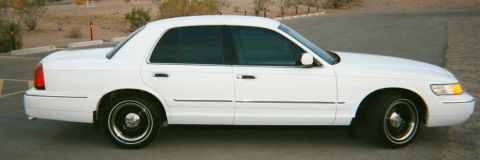 2001 Mercury Grand Marquis - A white 2001 Mercury Grand Marquis sedan is shown from the side, parked outdoors.