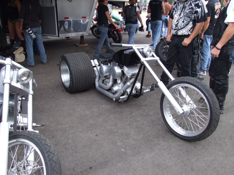 Custom trike motorcycle with wide rear tire and exposed engine