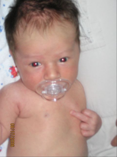 1994 Ford Bronco - A baby is shown with a pacifier in its mouth and a date stamp on its chest.