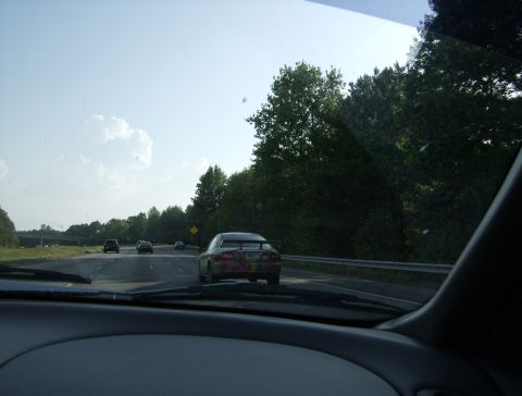 1998 Ford Taurus - View from inside a vehicle traveling on a highway with other cars on the road.