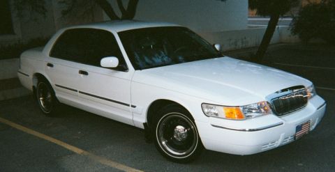2001 Mercury Grand Marquis - A white 2001 Mercury Grand Marquis sedan is shown from the front three-quarter angle.