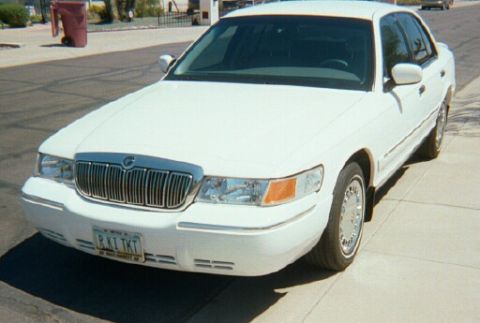 2001 Mercury Grand Marquis - Front view of a white 2001 Mercury Grand Marquis sedan parked on a paved surface.