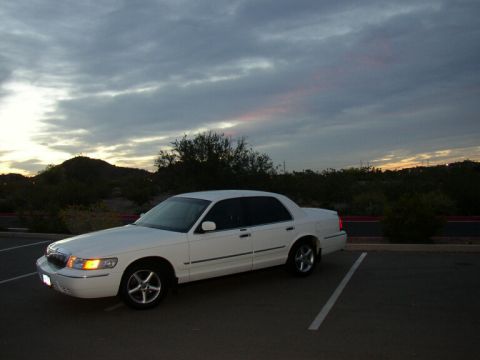 2001 Mercury Grand Marquis - White 2001 Mercury Grand Marquis parked in a lot during twilight.