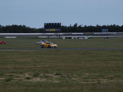 2001 Mercury Grand Marquis - Cars race on a track with a scoreboard in the background.