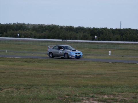2001 Mercury Grand Marquis - A silver Subaru Impreza WRX STI with racing decals navigates a track, possibly from the early 2000s.