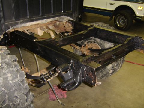 1986 Ford Ranger - The rear suspension and frame of a truck are visible, with another vehicle in the background.