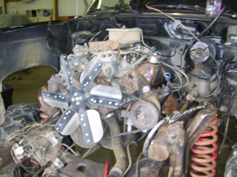 1986 Ford Ranger - The engine bay of a truck is shown, with the engine removed and various components exposed.