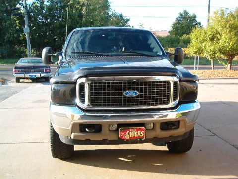 2000 Ford Excursion - The front of a 2000 Ford Excursion is shown, with a Chiefs license plate and another vehicle in the background.