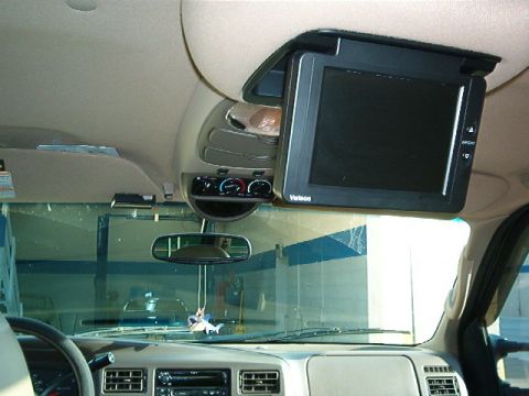 2000 Ford Excursion - The interior of a 2000 Ford Excursion shows an overhead entertainment screen and climate controls.