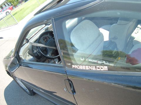 1991 Ford Probe - A sticker on the car window reads "PROBESNW.COM" next to the interior of the vehicle.
