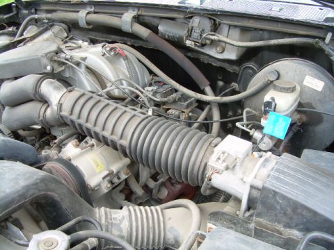 1994 Ford Bronco - Close-up view of an engine bay, showing the air intake system and other engine components.