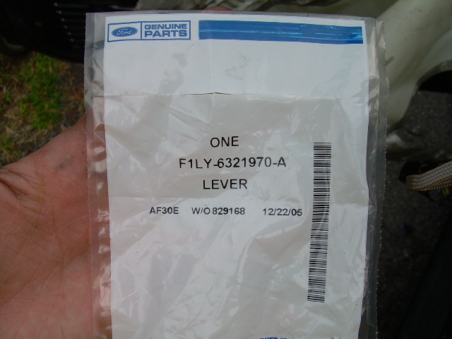 Ford Genuine Parts bag labeled F1LY-6321970-A lever, held in hand
