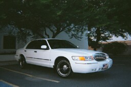 2001 Mercury Grand Marquis - White 2001 Mercury Grand Marquis sedan parked in a lot.