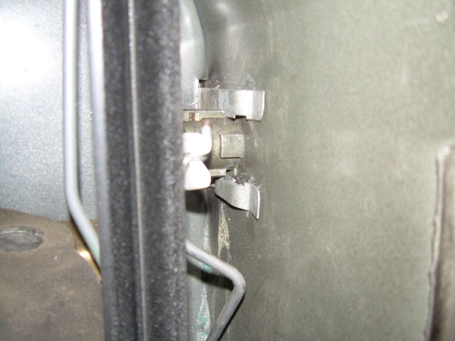 Interior door latch mechanism with wires and metal clips