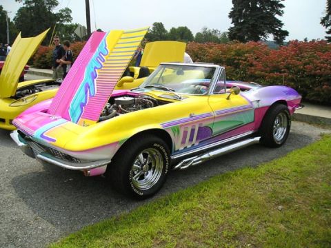 1984 Pontiac Fiero - Custom painted 1965 Corvette convertible with hood open, parked next to another yellow car.