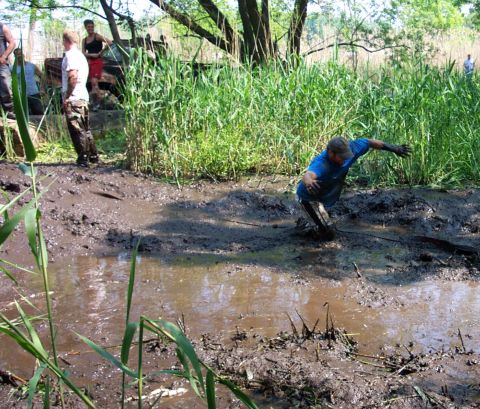1978 Ford Bronco - Off-road vehicle enthusiasts navigate a challenging mud pit during an event.