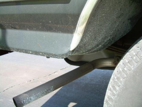 1992 Ford Bronco - Exhaust pipe and tire detail on a vehicle.