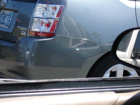 1995 Ford Taurus - Rear view of a gray Toyota Prius, showing the taillight assembly and a portion of the license plate.