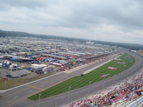 1971 Ford Ranchero - A vast parking area for RVs and trailers surrounds a race track, indicating a large event is underway.