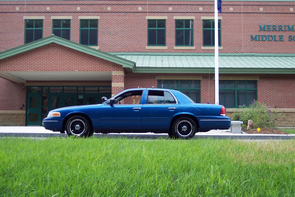 Blue 2001 Ford Crown Victoria sedan, side view