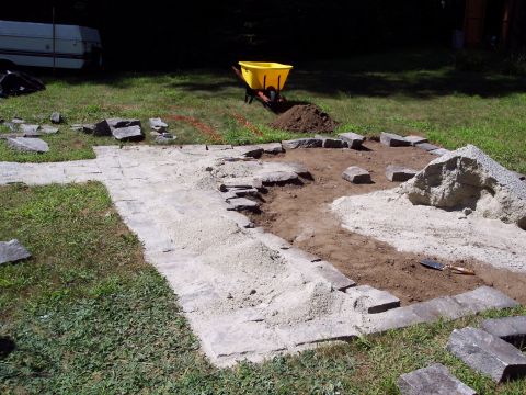 2001 Ford Crown Victoria - A trailer and wheelbarrow are visible in the background of a yard undergoing patio construction.