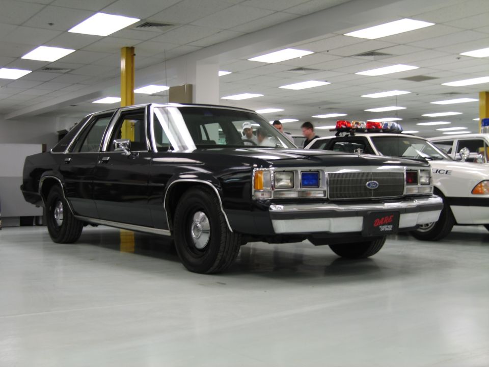 Black police car with DARE logo on front bumper