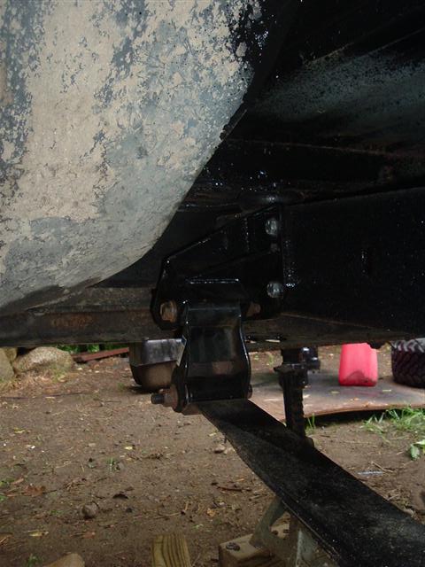 1991 Ford Bronco - The underside of a vehicle is shown, focusing on the suspension system and a leaf spring.