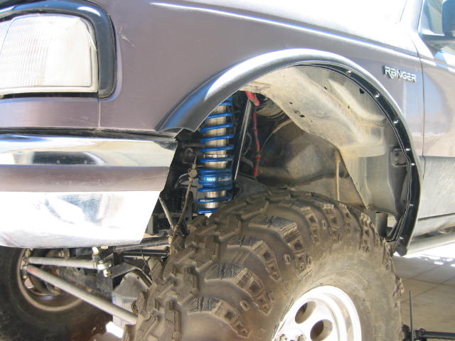 Purple 1997 Ford Ranger front fender with blue coilover suspension and large off-road tire
