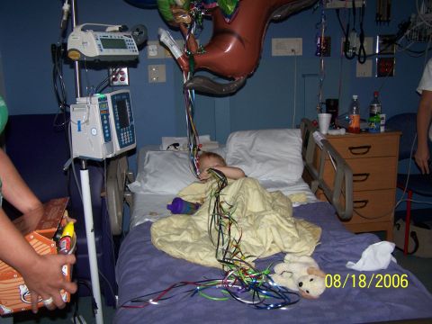 1979 Ford F-150 - A child lies in a hospital bed decorated with balloons and streamers, with medical equipment nearby. The image is dated August 18, 2006.