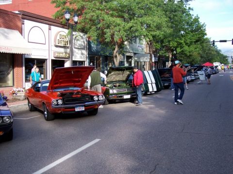 1972 Ford Ranchero - Several cars are parked on a street with their hoods up, suggesting a car show.