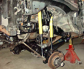 1984 Ford Bronco - The underside of a vehicle is shown, suspension components and a Supermotors.net logo.