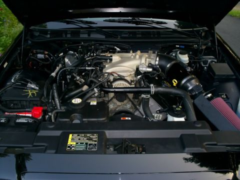 2003 Mercury Marauder - The engine bay of a car is shown with the hood open, revealing the engine components and wiring.