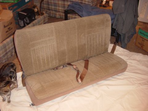 1991 Ford Bronco - A tan fabric bench seat with seatbelts is shown, likely a vehicle interior part.