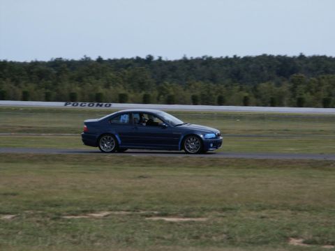 2001 Mercury Grand Marquis - A blue coupe drives on a racetrack with a 'POCONO' sign in the background.