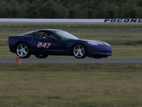 2001 Mercury Grand Marquis - A blue Chevrolet Corvette is seen on a race track with the number 247 displayed on its side.