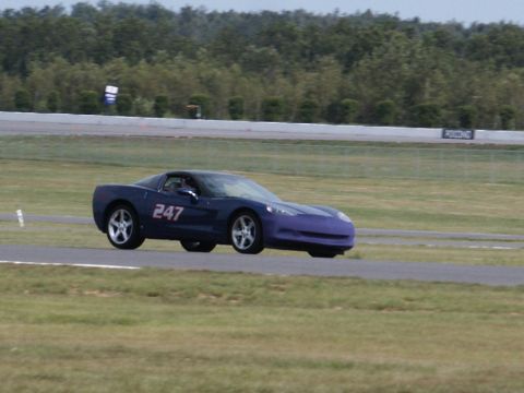 2001 Mercury Grand Marquis - Chevrolet Corvette with racing number 247 on a race track, showing a two-tone paint scheme.