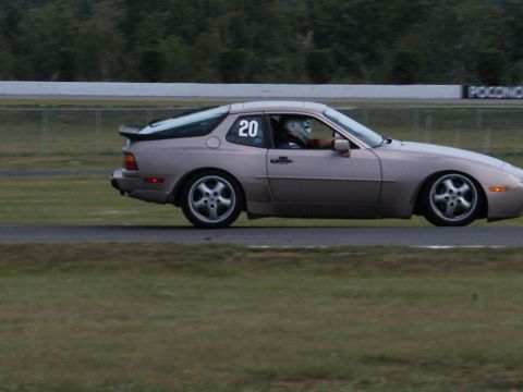 2001 Mercury Grand Marquis - A Porsche 944 is seen on a race track, displaying the number 20 on its side.
