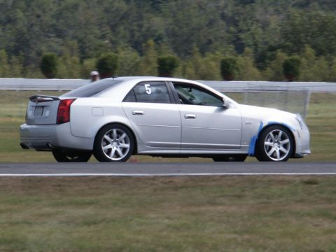 2001 Mercury Grand Marquis - Silver sedan with racing number 5 on the door, seen from the side on a race track.