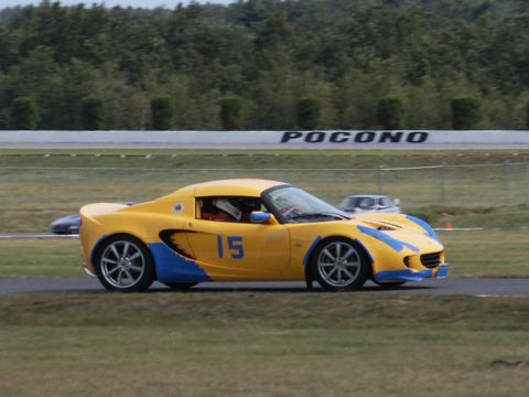2001 Mercury Grand Marquis - A yellow and blue sports car, number 15, races on a track with 'POCONO' visible in the background.