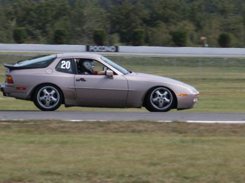 2001 Mercury Grand Marquis - A Porsche 944 is seen on a race track with a driver wearing a helmet.