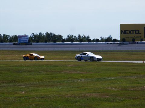 2001 Mercury Grand Marquis - Two cars race on a track with a large Nextel sign visible in the background.