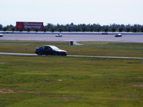 2001 Mercury Grand Marquis - A dark coupe navigates a race track, with a large Budweiser Racing billboard visible in the background.