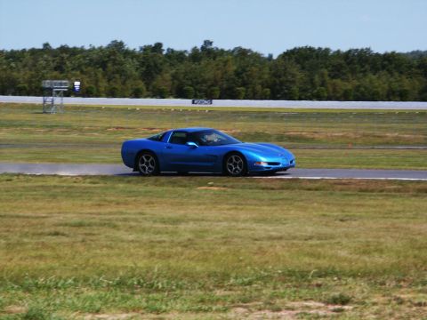2001 Mercury Grand Marquis - A blue Chevrolet Corvette C5 is seen driving on a race track.