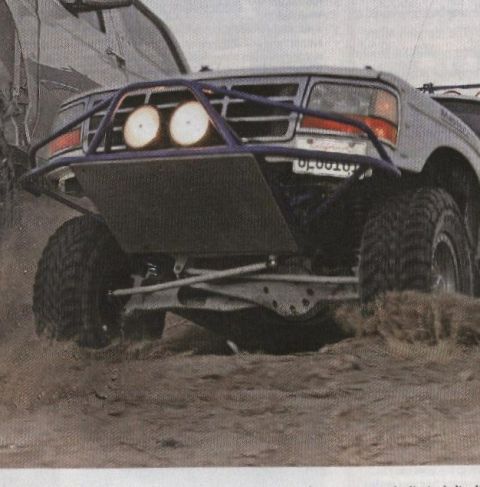 1984 Ford Bronco - Modified 1992 Ford Bronco with custom front bumper and lights navigating rough terrain.