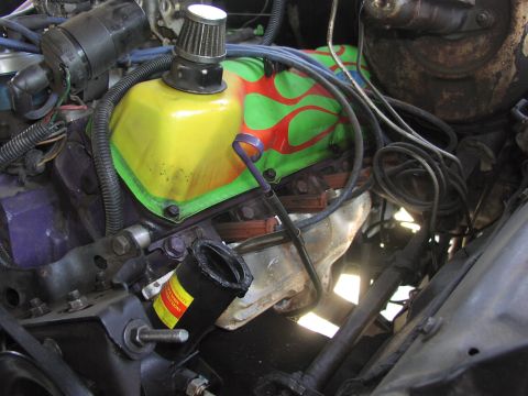 1979 Ford Bronco - Close-up of an engine bay, a custom-painted valve cover with flame graphics and a small air filter.